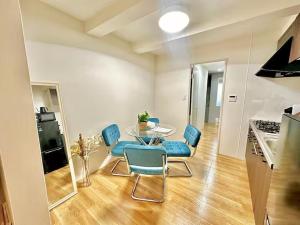 a dining room with a glass table and blue chairs at YADORI - Vacation STAY 81027v in Osaka +14 photos