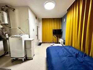a hospital room with a bed and yellow curtains at Coop Sunlight - Vacation STAY 19687 in Sapporo