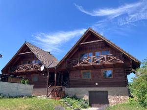 a log home with a blue sky in the background at Barbora chata in Nitrianske Rudno