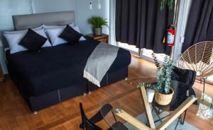 a bedroom with a bed and a table with a cactus at Abitare Mezcala 1 in Isla de Mezcala