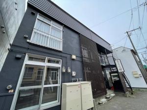 a black building with a window on the side of it at Sakura Kan - Vacation STAY 19678 in Sapporo