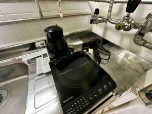 a coffee maker sitting on top of a kitchen counter at Coop Sunlight - Vacation STAY 19686 in Sapporo +7 photos