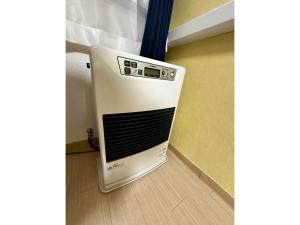 a microwave oven sitting on the floor in a room at Coop Sunlight - Vacation STAY 19686 in Sapporo