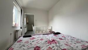 a bedroom with a bed with a crib in it at Ferienwohnung Harzgebirge in Goslar