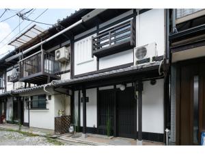 a white building with a balcony and an air conditioner at TSUBOMI luxury Inn Shimabara Bettei 3 - Vacation STAY 84311v in Kyoto