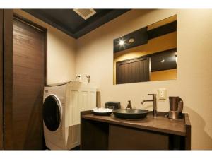 a bathroom with a sink and a washing machine at TSUBOMI luxury Inn Shimabara Bettei 3 - Vacation STAY 84311v in Kyoto +15 photos