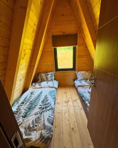 a room with two beds in a wooden cabin at Villa Roi 3 in Ferizaj
