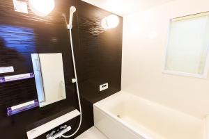 a bathroom with a bath tub and a sink at Prosper No, 40 - Vacation STAY 19720 in Nagoya