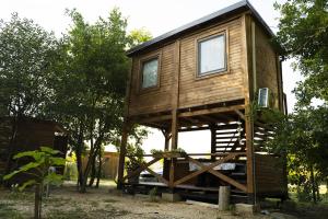 a tree house sitting on top of a wooden structure at Super cute Treehouse by the river in Mostar