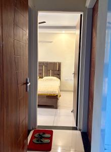 a bedroom with a bed and a red rug at Chandigarh Waale, Furnished Stay in Zirakpur in Zirakpur +1 photo