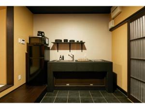 a kitchen with a sink and a refrigerator at TSUBOMI luxury Inn Shimabara Bettei 1 - Vacation STAY 83230v in Kyoto