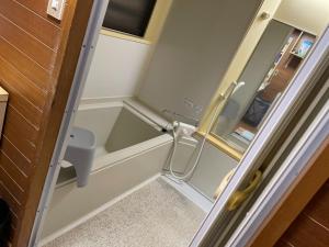 a small bathroom with a sink and a mirror at Kominka Mimi - Vacation STAY 19741 
