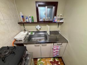 a small kitchen with a sink and a stove at Sea hut - Vacation STAY 83423v in Gima +56 photos