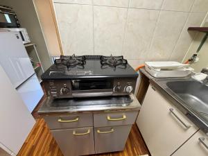 a kitchen with a stove and a sink at Sea hut - Vacation STAY 83423v in Gima