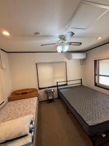 a room with two beds and a chalkboard on the wall at Sea hut - Vacation STAY 83423v in Gima