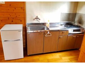 a kitchen with a sink and a stove at Ume Camp Mura - Vacation STAY 88863v in Saiki
