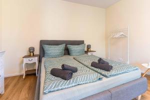 a bedroom with a large bed with pillows on it at LITZI Apartment in Baden-Baden