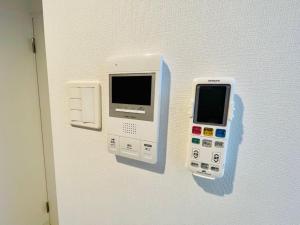een muur met een elektronisch apparaat aan een muur bij Cream Building - Vacation STAY 19747 in Sapporo