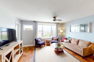 a living room with a couch and a tv at Turn of River 4F in Folly Beach