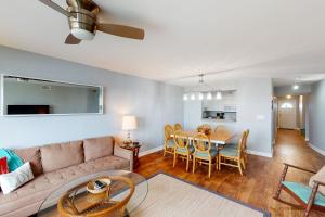 a living room with a couch and a table at Turn of River 4F in Folly Beach