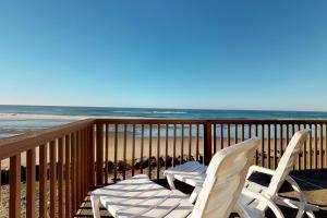 two chairs sitting on a balcony overlooking the beach at Pacific Sands Resort #22 in Neskowin
