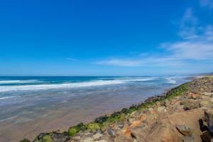 a view of the ocean from a rocky beach at Pacific Sands Resort #22 in Neskowin