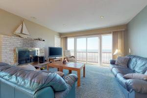 a living room with two couches and a fireplace at Pacific Sands Resort #22 in Neskowin +33 photos