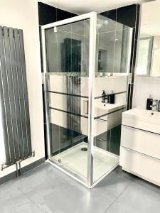 a glass shower in a bathroom with a sink at Relaxed Leigh-on-Sea Escape, Family-Friendly & Contractor Stays in Hockley