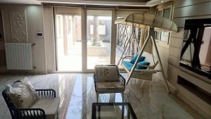 a living room with a chair and a swing at The Park Residence - ذا بارك ريزدنس in Cairo