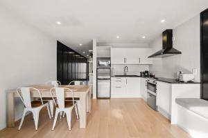 a kitchen and dining room with a table and chairs at Wanaka Ridge in Wanaka