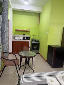a kitchen with a table and chairs in a room at JarAirbnb in Pucallpa