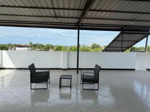 a group of chairs and a table on a patio at JarAirbnb in Pucallpa