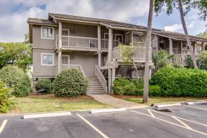 a apartment building with a balcony and a parking lot at Lagoon Villa 24 in Isle of Palms