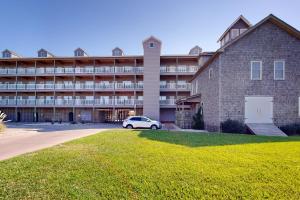 a car parked in front of a large building at Wahoo 814 #102DS-H in Hatteras