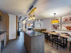 a kitchen and living room with a table and chairs at Chalet moderne avec parking et wifi, à proximité des pistes et commerces - FR-1-566-20 in Les Allues +7 photos