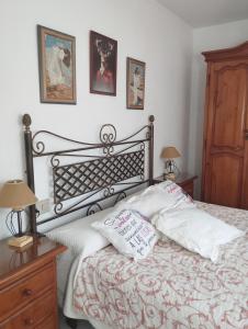 a bedroom with a bed with two pillows on it at Rincón de descanso in Ponferrada