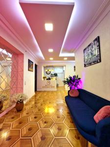 a living room with a blue couch in a room at Hotel Tiflis Town in Tbilisi City