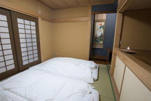 Postel nebo postele na pokoji v ubytování 爽音の宿 静sei 富士河口湖