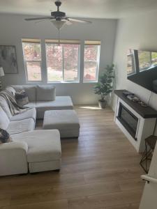 a living room with two couches and a tv at Peace in the Pines in Flagstaff