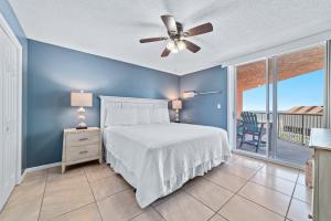 a bedroom with a bed and a ceiling fan at Buena Vista Unit 305 in Gulf Shores