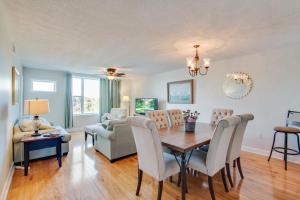 a dining room and living room with a table and chairs at Turn Of River 2F in Folly Beach