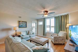 a living room with a couch and a tv at Turn Of River 2F in Folly Beach