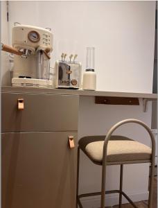 a counter with a sewing machine and a chair on it at Stylish studio 3-4p with AC and balcony near Champs-Élysées in Paris