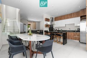 a kitchen and dining room with a table and chairs at Las Villas - Townhomes & Condos in Eastside Bucerias in Bucerías