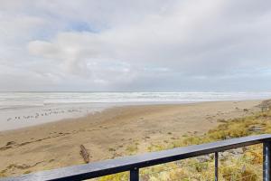a view of the beach from a balcony at On The Sand in Rockaway Beach