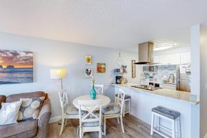 a kitchen and living room with a couch and a table at On The Sand in Rockaway Beach