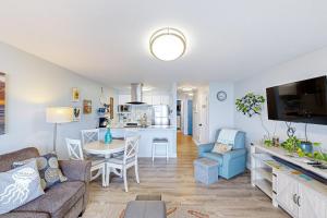 a living room with a couch and a dining room at On The Sand in Rockaway Beach