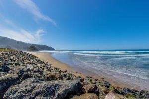 a beach with some rocks and the ocean at Pacific Sands Resort #19A in Neskowin