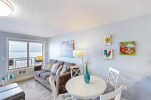 a living room with a couch and a table at On The Sand in Rockaway Beach +24 photos