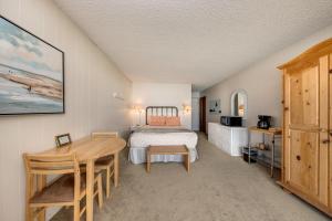 a bedroom with a bed and a table and a desk at Pacific Sands Resort #19A in Neskowin